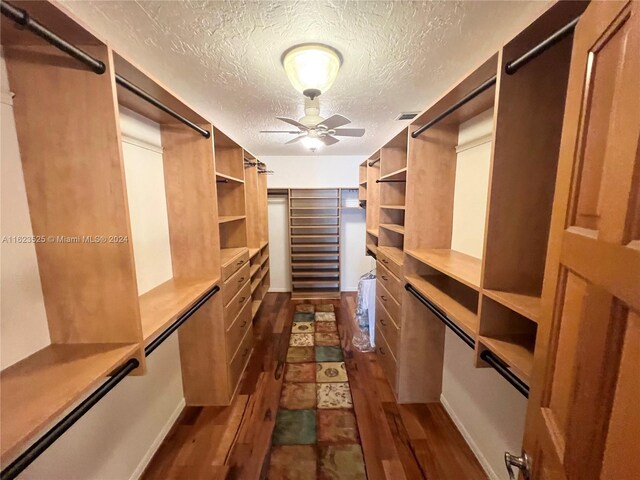 spacious closet featuring dark hardwood / wood-style flooring and ceiling fan