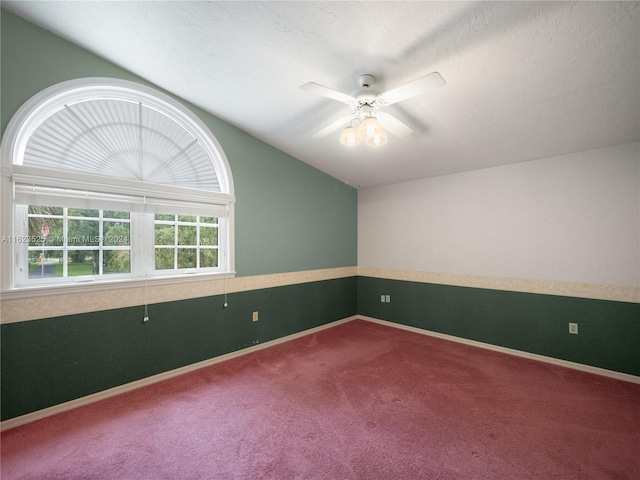 carpeted empty room featuring a textured ceiling and ceiling fan