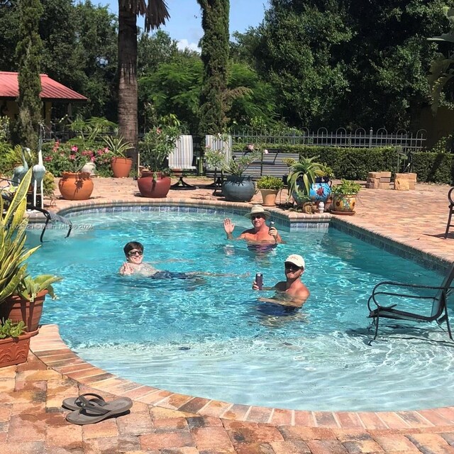 view of swimming pool with a patio