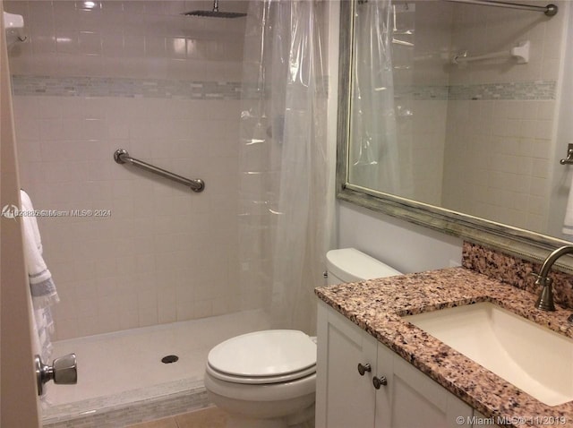 bathroom featuring tile patterned flooring, vanity, toilet, and a shower with shower curtain