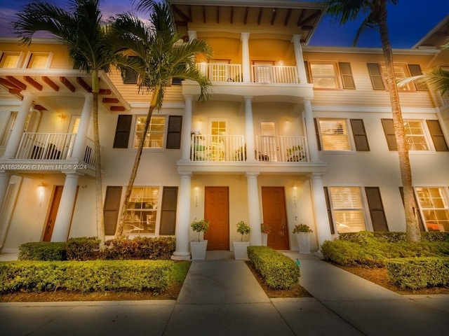 4159 Main St, Jupiter, FL 33458 - view of front of house with stucco siding and a balcony