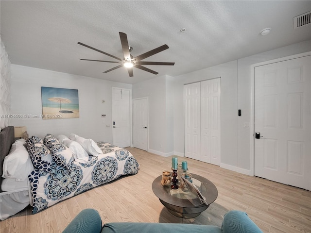 bedroom with light wood-type flooring and ceiling fan