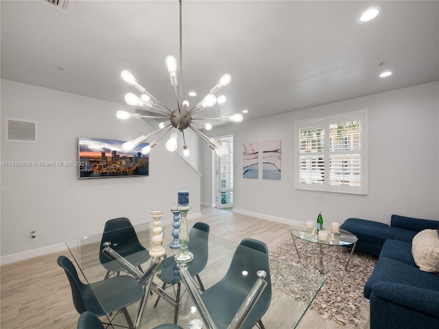 dining area with a chandelier and light hardwood / wood-style floors