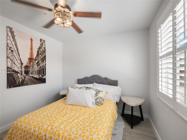 bedroom with hardwood / wood-style floors and ceiling fan