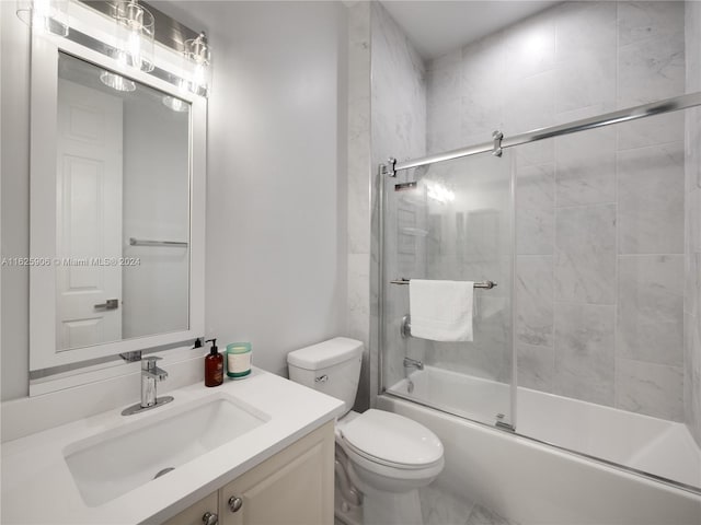 full bathroom featuring vanity, toilet, and enclosed tub / shower combo