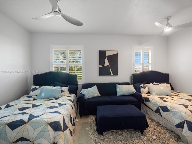 bedroom with ceiling fan and wood-type flooring