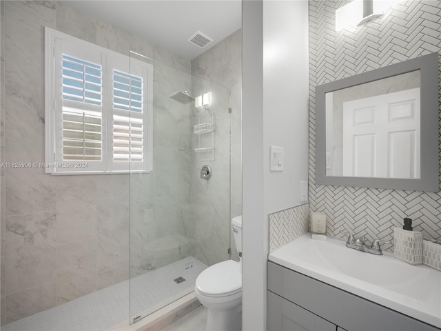 bathroom featuring vanity, an enclosed shower, tile walls, and toilet