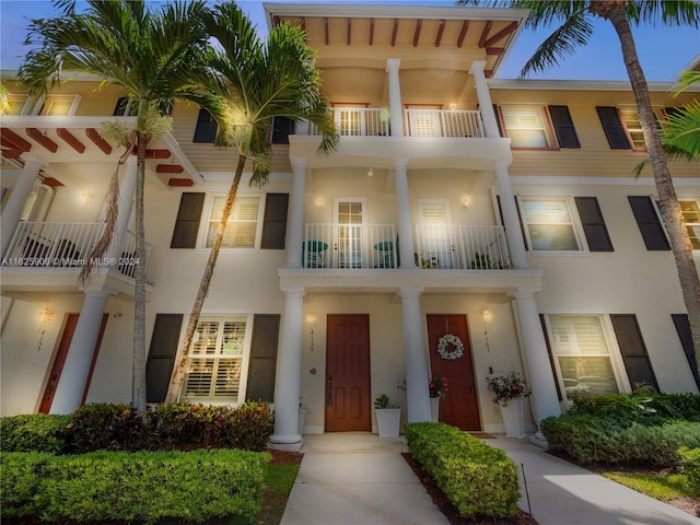 4159 Main St, Jupiter, FL 33458 - view of front facade with a balcony and stucco siding