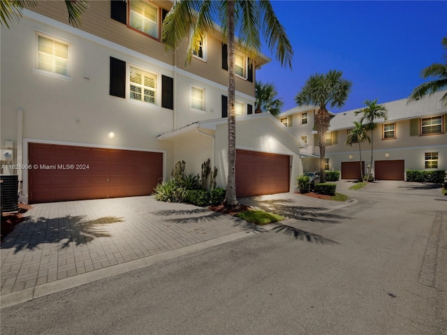 4159 Main St, Jupiter, FL 33458 - view of front of home with stucco siding, an attached garage, and driveway