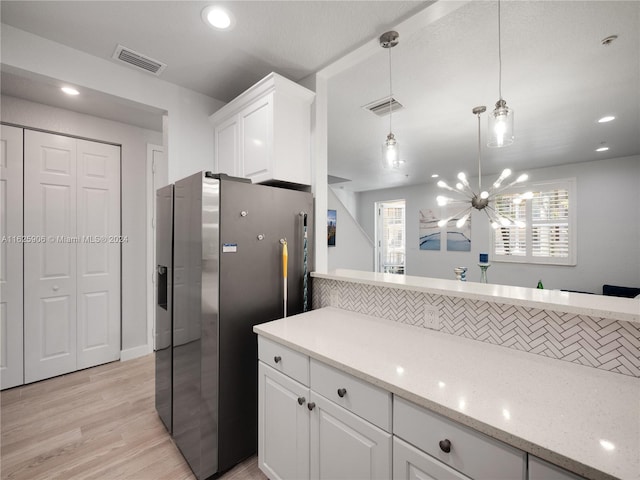 kitchen with pendant lighting, light hardwood / wood-style flooring, white cabinets, and stainless steel fridge with ice dispenser