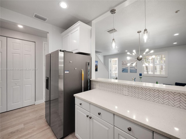 4159 Main St, Jupiter, FL 33458 - kitchen featuring stainless steel fridge with ice dispenser, light wood-style floors, white cabinetry, pendant lighting, and a chandelier