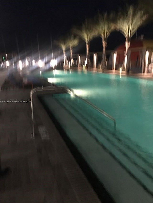 view of pool at twilight