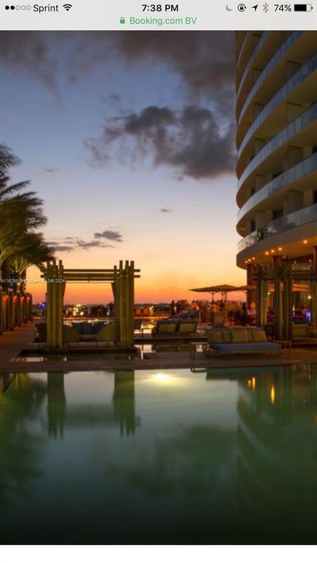 view of pool at dusk