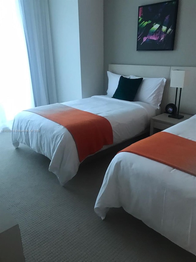 carpeted bedroom featuring multiple windows