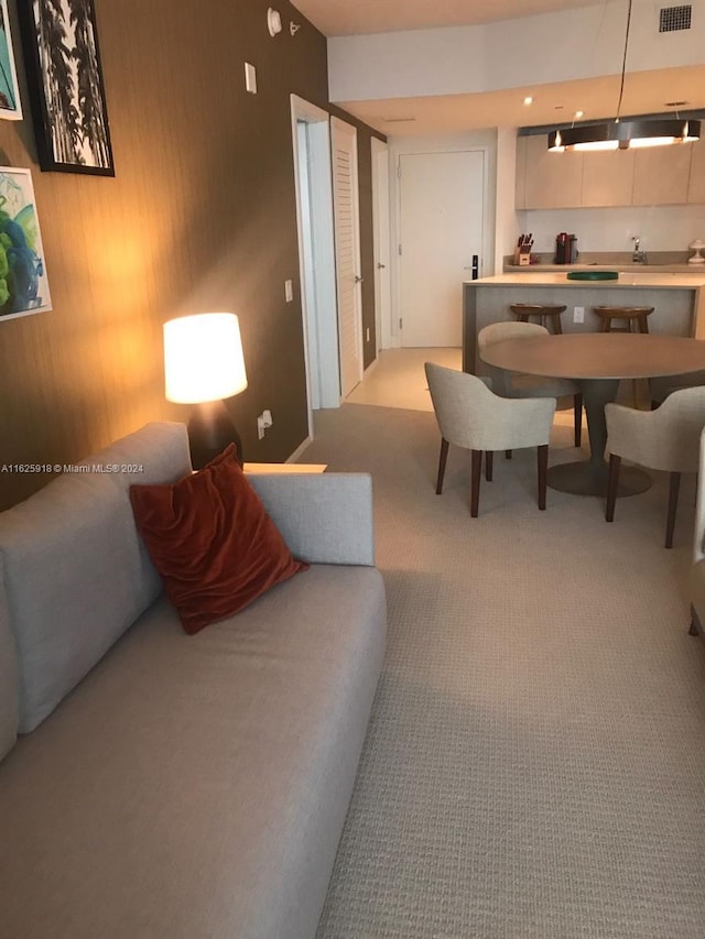 living room featuring wood walls and light carpet