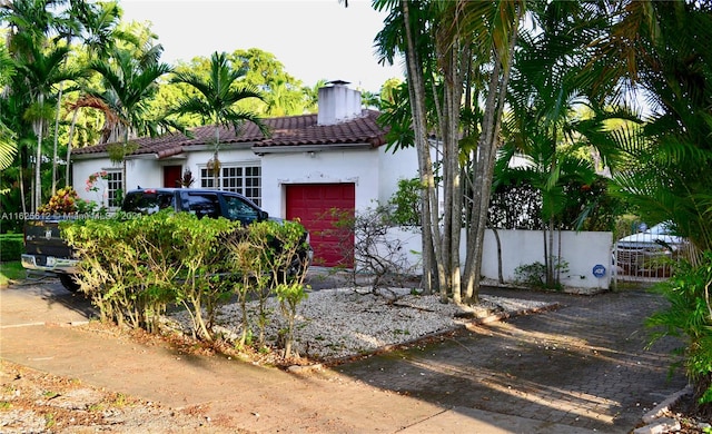 mediterranean / spanish-style home featuring a garage