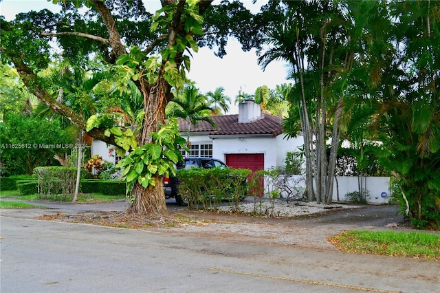 view of side of property with a garage