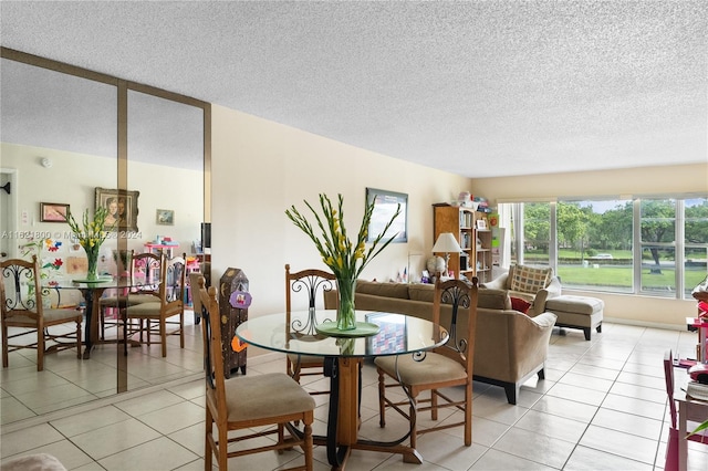 tiled dining area with a textured ceiling