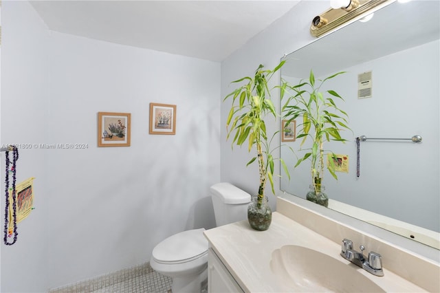 bathroom with vanity, toilet, and tile patterned floors