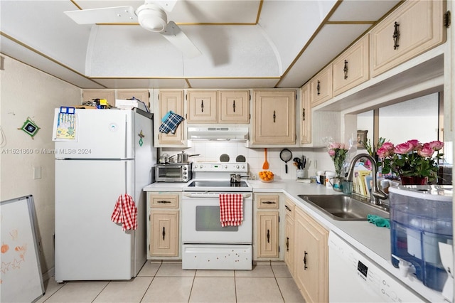 kitchen with light tile patterned flooring, light brown cabinetry, decorative backsplash, white appliances, and sink