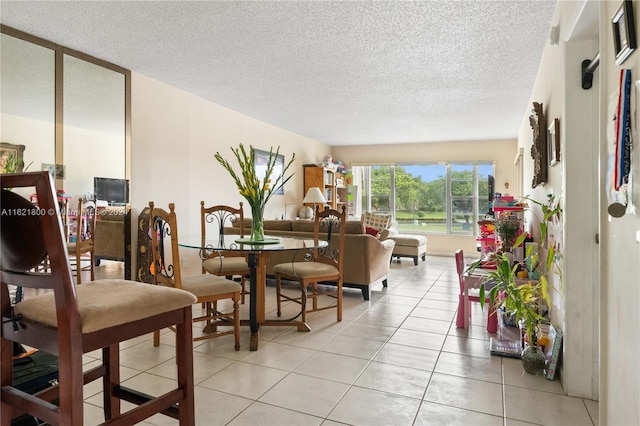 living room featuring a textured ceiling and light tile patterned floors