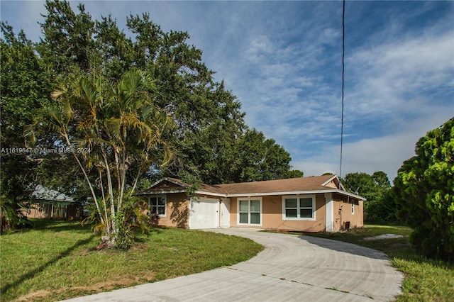 ranch-style house with a front yard and a garage