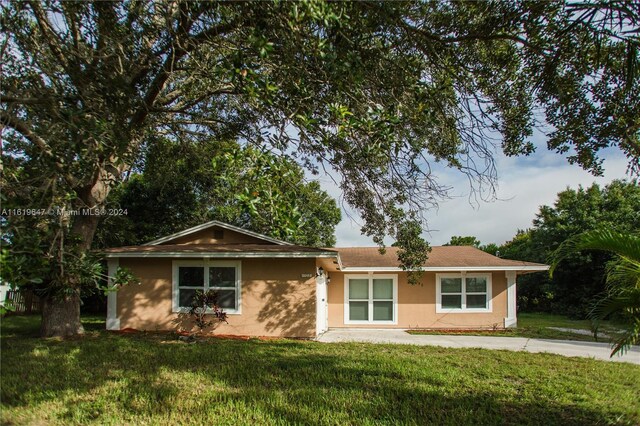 ranch-style home with a front lawn