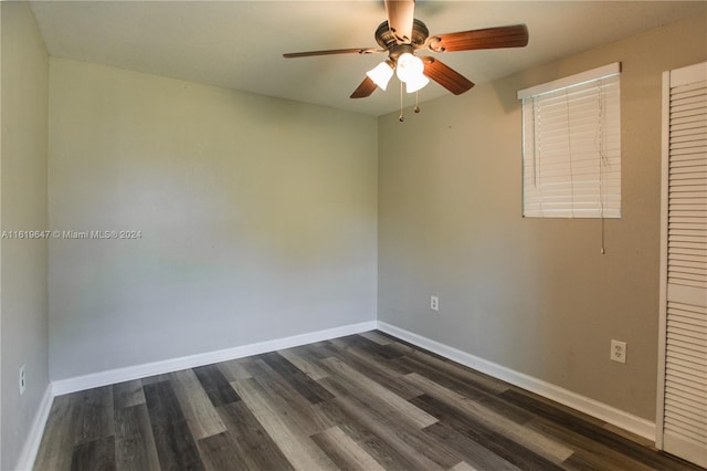 empty room featuring ceiling fan and dark hardwood / wood-style flooring