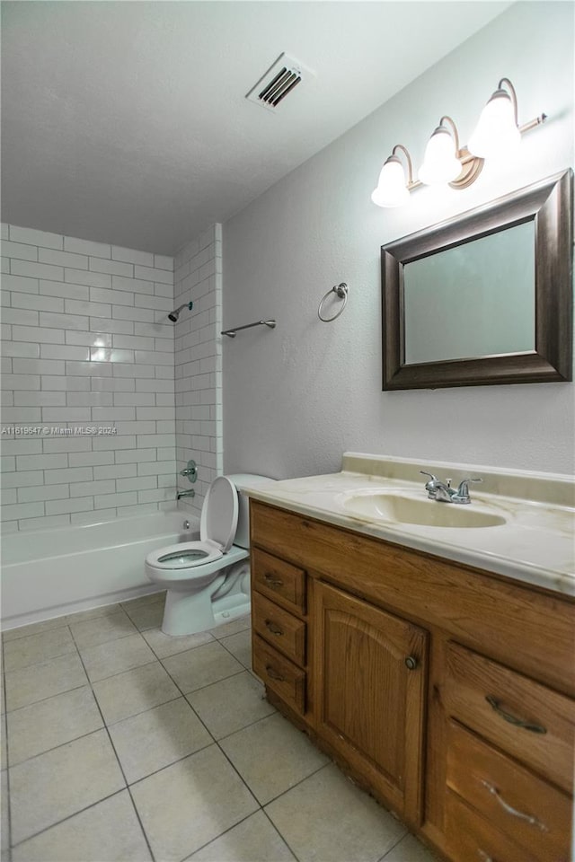 full bathroom with toilet, tile patterned floors, vanity, and tiled shower / bath combo