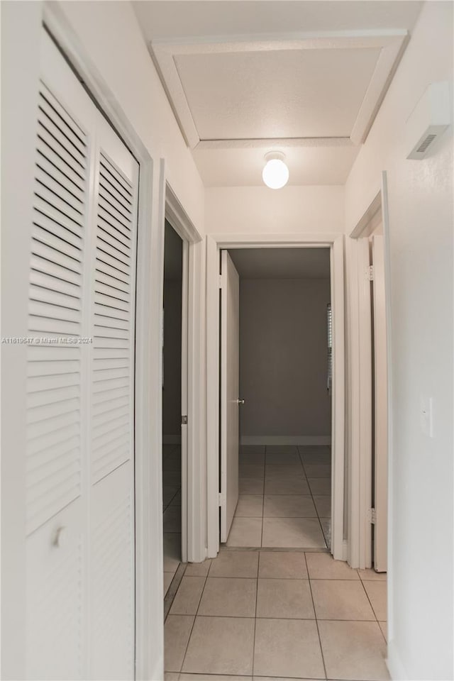 corridor featuring light tile patterned flooring