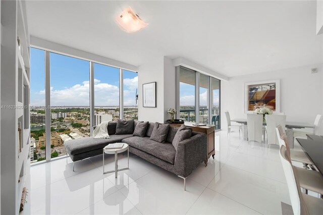 living room with light tile patterned flooring, plenty of natural light, and a wall of windows