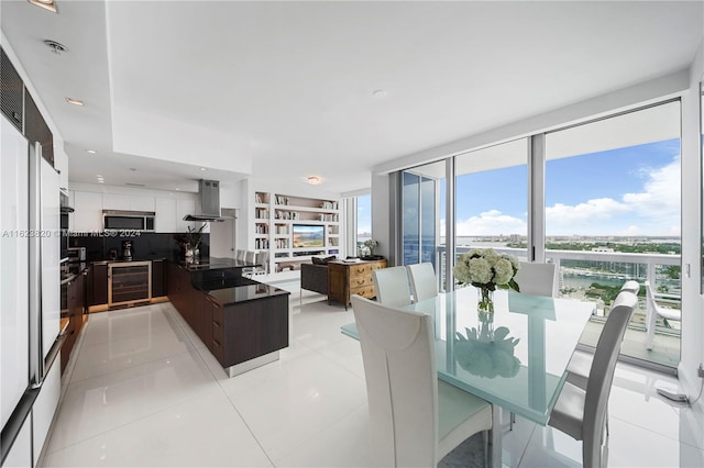 dining area with wine cooler, light tile patterned floors, and floor to ceiling windows