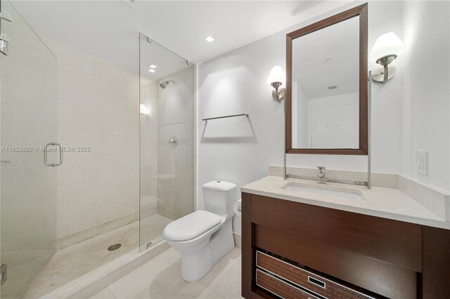 bathroom with toilet, a shower with shower door, and vanity