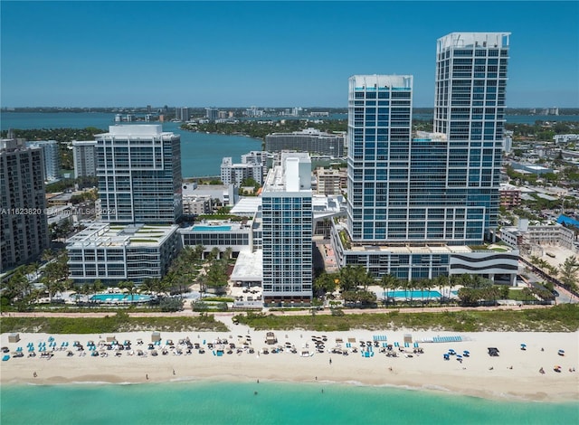 drone / aerial view featuring a water view and a view of the beach