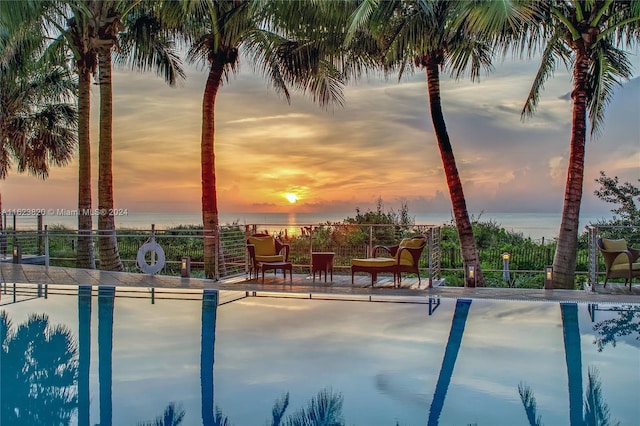 pool at dusk with a water view