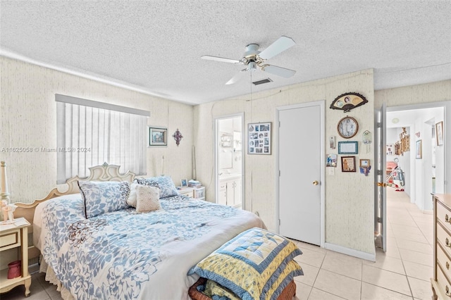 bedroom with light tile patterned floors, ensuite bathroom, a textured ceiling, and ceiling fan