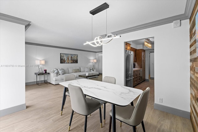 dining area with crown molding and light wood-type flooring