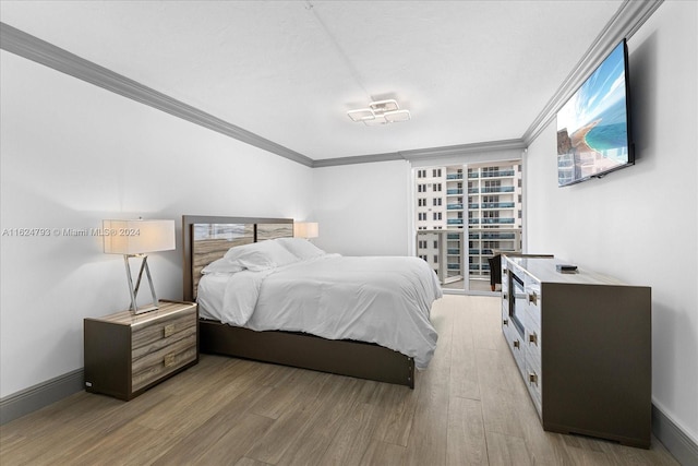 bedroom featuring hardwood / wood-style flooring and ornamental molding