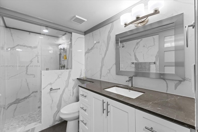 bathroom featuring tile walls, a tile shower, vanity, ornamental molding, and toilet