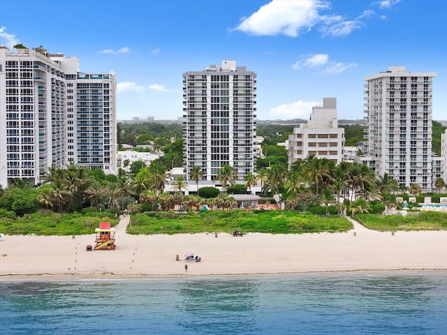 view of swimming pool featuring a view of the beach and a water view