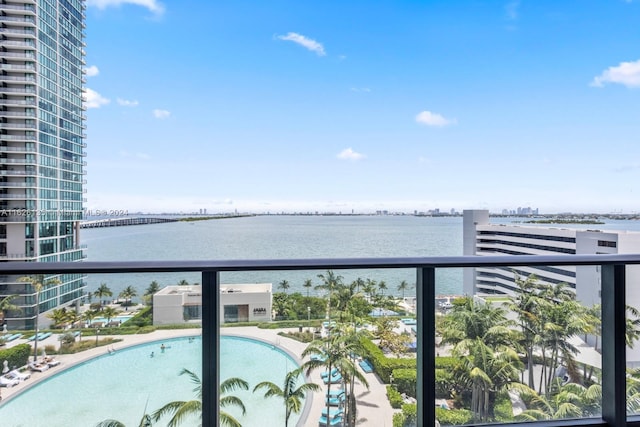 balcony featuring a community pool and a water view