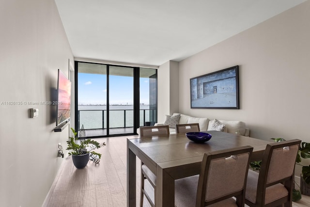 480 NE 31st St Unit 1005, Miami, FL 33137 - dining space with floor to ceiling windows and light wood finished floors