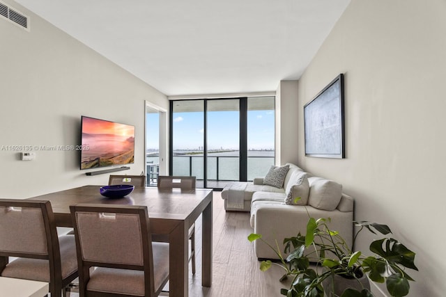 480 NE 31st St Unit 1005, Miami, FL 33137 - living area with a wall of windows and wood finished floors