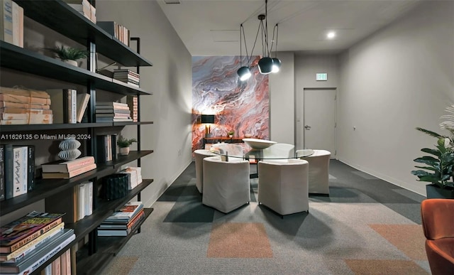 dining space with dark colored carpet