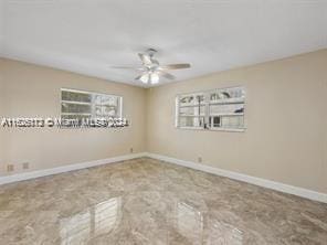 unfurnished room featuring ceiling fan