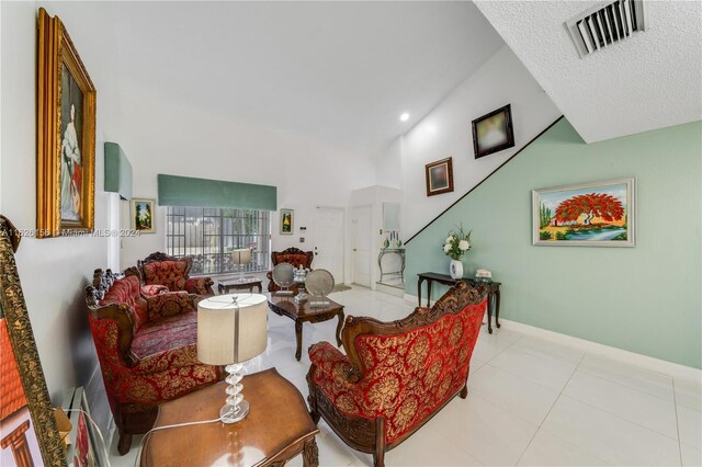 interior space featuring high vaulted ceiling and a textured ceiling