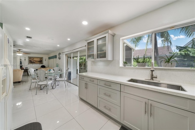 kitchen with light tile patterned flooring, visible vents, glass insert cabinets, and recessed lighting