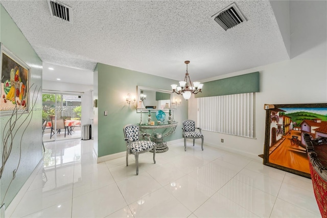 sitting room with visible vents, a textured ceiling, baseboards, and a chandelier