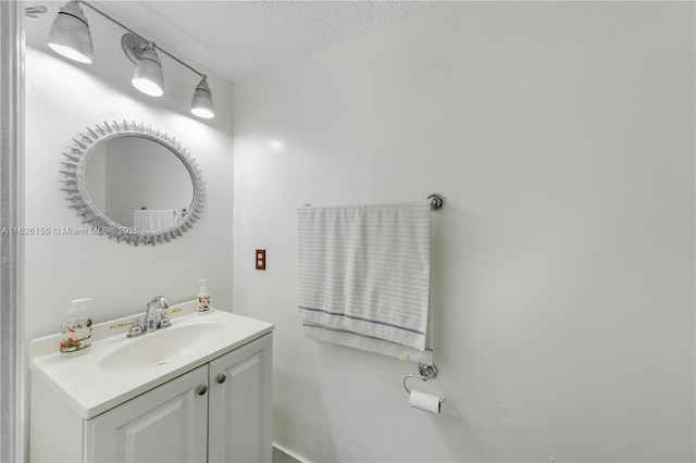 bathroom featuring vanity and a textured ceiling