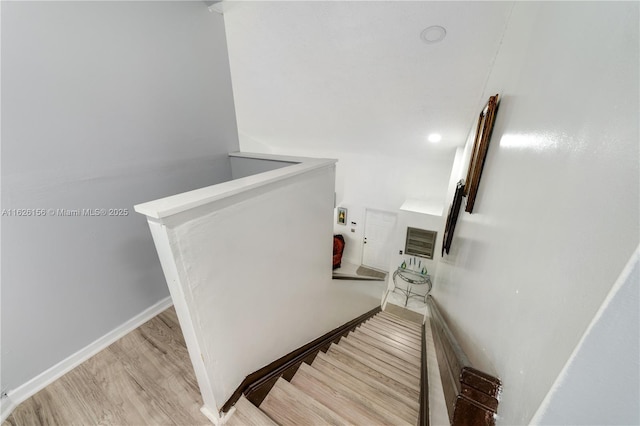 stairs featuring baseboards and wood finished floors